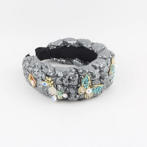 Detail of denim knotted headband with grey sequins, 3D butterfly, floral and perfume charms