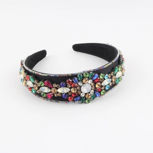 Detail of vintage headband featuring multicolored crystals and pearls on black fabric base