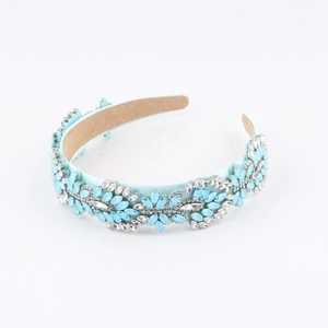 Detail view of sky blue baroque headband with shimmering crystals and silk fabric