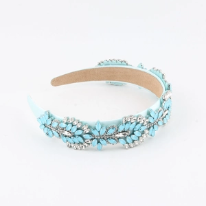 Detail of light blue satin headband featuring elegant blue and white crystal flower patterns