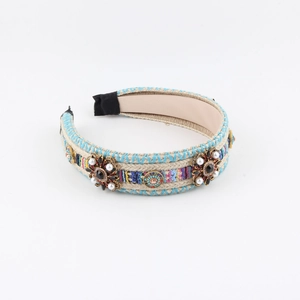 Bohemian braided wide headband with colorful embroidery, faux pearls and gems on white background