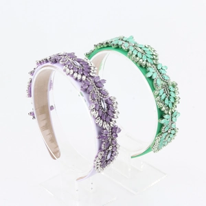 Close-up of handmade baroque fabric headbands with beads and crystals on display