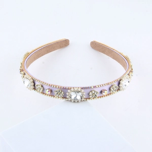 Macro shot of luxury lavender satin headband with large crystals and golden floral accents