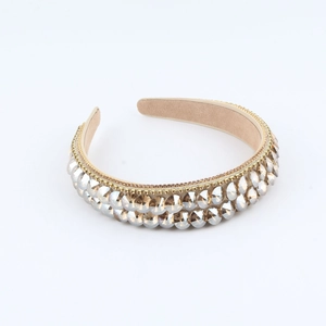 Baroque wide headband with champagne rhinestones and golden beads on a white background