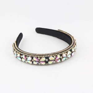 Close-up of colorful rhinestones on a black velvet headband for elegant parties
