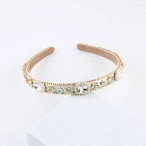 Luxurious padded headband with rhinestones, pearls, and crystal flowers on white block