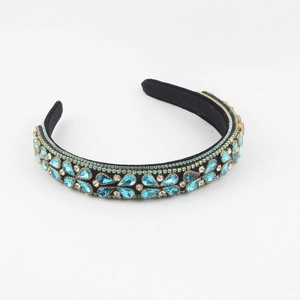 Luxurious wide velvet headband featuring light blue crystals and shimmering rhinestones