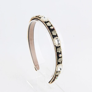Detailed macro view of luxury padded headband with crystal rhinestones and golden bead trim