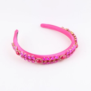 Detailed view of fuchsia satin headband with rhinestones and ruby-red jewels