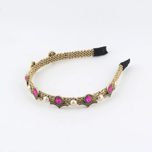 Detail of pink crystal and pearl embellishments on gold woven vintage headband