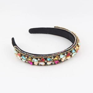 Detail of black velvet headband with colorful rhinestones and teardrop gemstones
