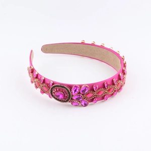 Detailed macro view of magenta satin headband with hand-set pink rhinestones and gems