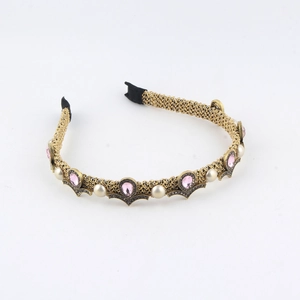 Detail of vintage gold pearl headband with pink teardrop crystal and baroque style weave