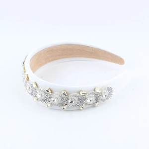 Detailed view of white fabric headband with sparkling rhinestones and non-slip lining