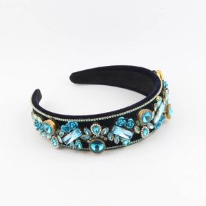Baroque retro blue velvet headband with crystals and golden rose details on white background