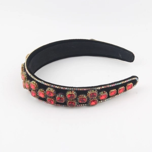 Detail of baroque double-layer headband with red crystals and rhinestones on black velvet