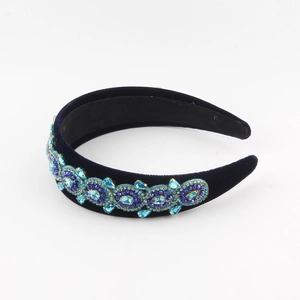 Deep blue velvet headband with baroque crystal patterns and rhinestones on a white background