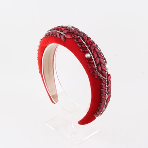 Detail of red velvet headband with rhinestones and marquise crystals in leaf pattern