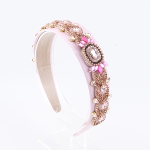 Detailed macro view of pink leather headband with handcrafted crystals and luxury rhinestones