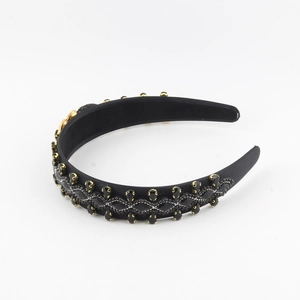 Detail of baroque headband featuring black satin, gold claw gems, and silver bead chains