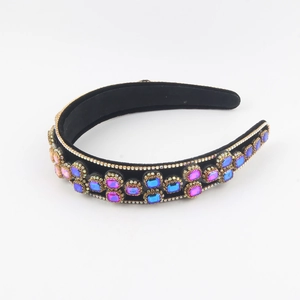 Detail of baroque black velvet headband with colorful square crystals and small rhinestones