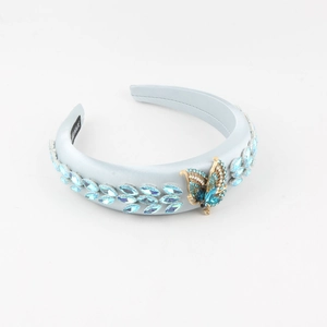 Serre-tête en tissu bleu orné de cristaux marquise et d'un papillon doré élégant