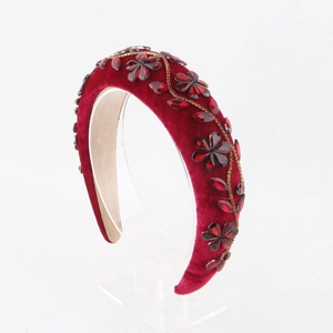 Detail view of burgundy velvet padded headband with sparkling crystal floral embroidery