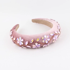 Detail of pink velvet headband with 3D crystal floral embellishments and golden beads