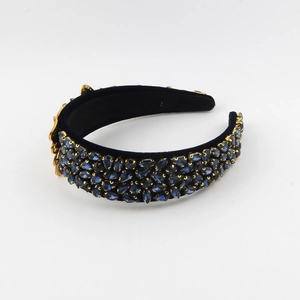 Detailed view of luxury baroque headband with blue crystals and gold flower accents