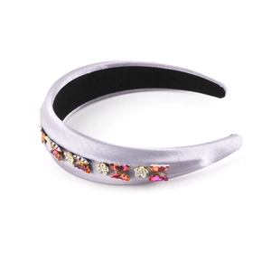 Detail of light purple satin headband with red rhinestone butterflies and silver flowers