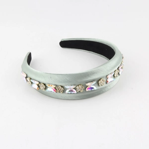Detail view of mint green padded headband featuring butterfly crystals and non-slip lining