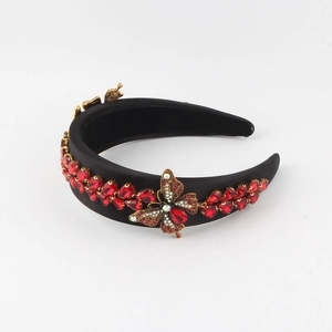 Detailed macro view of crystal butterfly ornament on vintage black velvet headband
