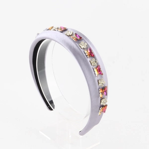 Close-up of light purple padded headband with resin butterfly and silver flower details