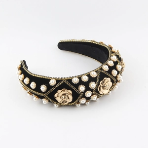 Detailed close-up of velvet headband featuring golden roses and pearl embellishments