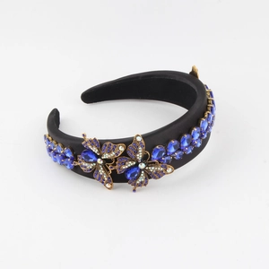 Baroque style headband with blue crystals and vintage golden butterfly accents on black satin