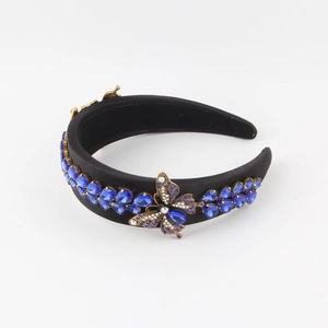 Close-up of luxury Baroque headband with blue rhinestones and crystal butterfly detail