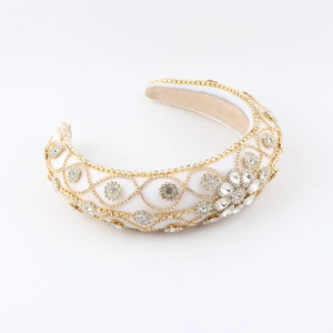 Baroque white fabric headband with intricate gold filigree and sparkling rhinestones
