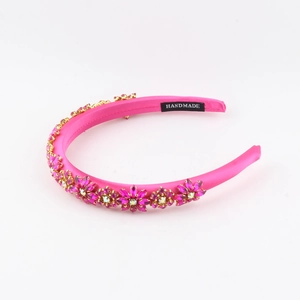 Detailed macro view of handmade fuchsia satin headband with sparkling floral rhinestones