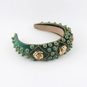 Baroque dark green velvet headband with gold roses and pearls on a white background