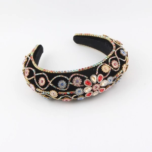 Detail of colorful rhinestones on velvet headband with intricate floral patterns