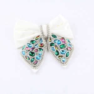 Elegant white satin bow hair claw with colorful rhinestones and pearls on white background