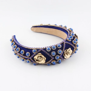 Detailed close-up of Baroque velvet headband with blue pearls and gold rose charms