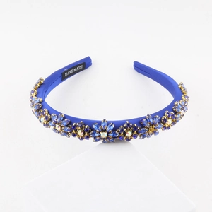 Macro detail of royal blue baroque headband with handmade label and crystal flowers