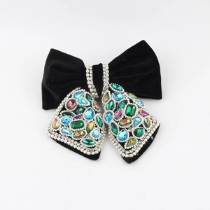 Detail of luxury black velvet bow hair claw clip with colorful rhinestones and pearls