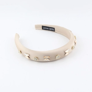Detail of satin sponge headband with crystal butterfly and handmade label
