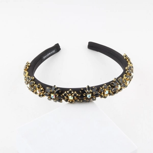 Baroque wide headband with black rhinestones and pearls on a white geometric stand