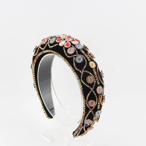 Close-up of vintage velvet headband with colorful rhinestones and floral pattern detail