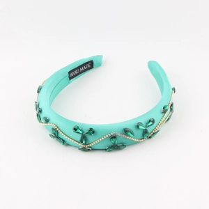 Vintage baroque headband with green crystals, gold chain, and teal sponge fabric