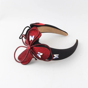 Sparkling crystal flower headband with large red rhinestone bow and glitter butterfly decor