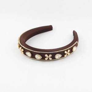 Padded headband with champagne crystals and floral rhinestones on a brown satin base
